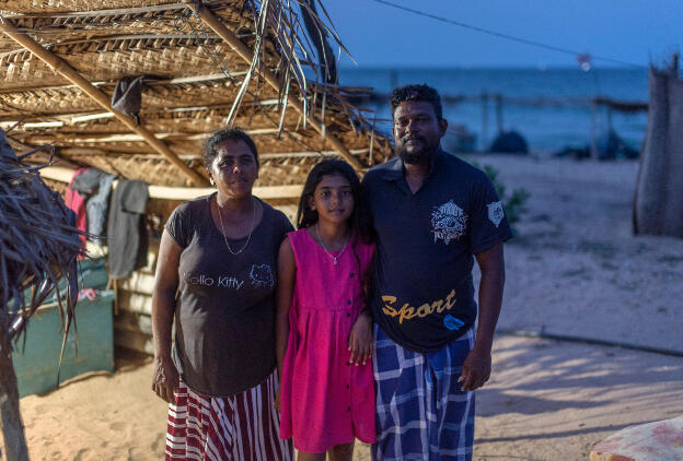 Kumpurupiddi Beach, Sri Lanka: Shiromi, Seruni (12), Nelson (40); son (16) is out playing cricket. Fresh water pipe that they are happy about on the floor, boat in very background. Catching flying fish, tuna, leaving at sunrise.