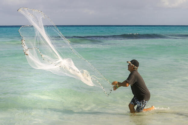 Fisherman throwing net at Varadero beach