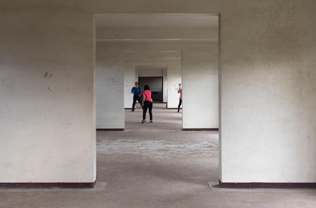 Kaohsiung, Taiwan: Weiwuying Metropolitan Park - Empty building where people play badminton