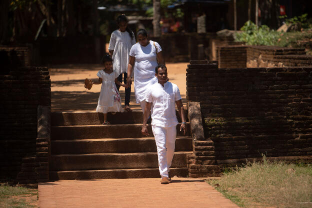 Familiy visiting the well conserved moonstone at Anuradhapura, Sri Lanka