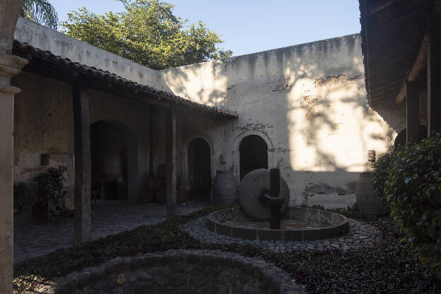 Historic agave press in the Fábrica La Rojeña, Tequila