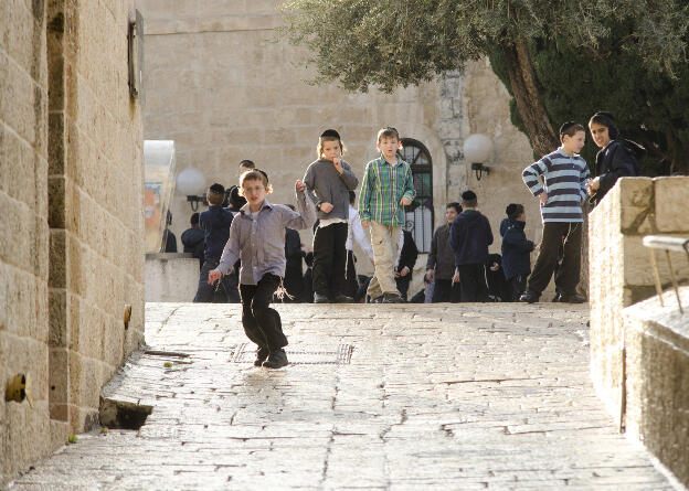 Pupils in streets of Jerusalem, sliding on wet floor